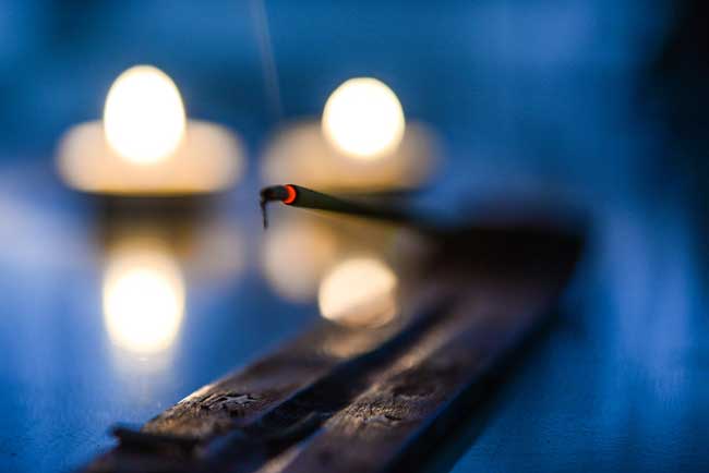 Placing the incense stick in the holder