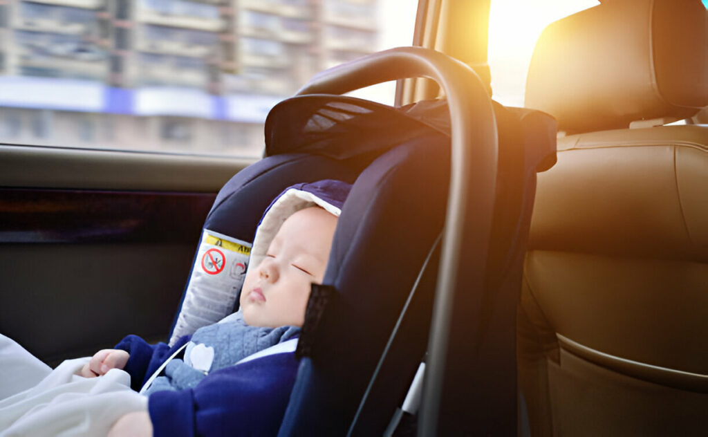 a baby sleeping in a car seat